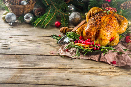 Traditional Christmas and Thanksgiving roasted whole chicken with fruit and rosemary.の写真素材