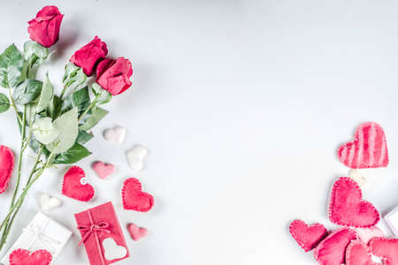 Valentines Day background with handmade red textile hearts,red ribbon and roses. White background  flaylay pattern top view copy spaceの写真素材