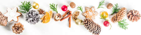 Christmas festive background with xmas fir tree branches, pine cones and decorations on white.