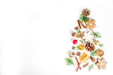 Christmas festive background with xmas fir tree branches, pine cones and decorations on white.