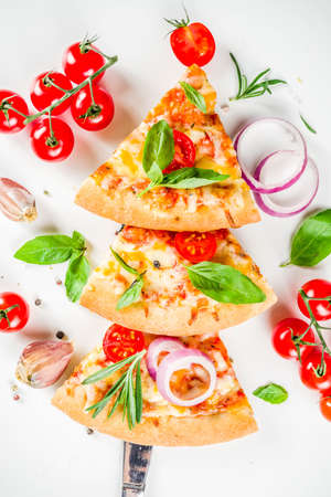Pieces of cheese pizza Margarita, set like christmas tree. White stone background top view. Christmas and New year party food ideaの写真素材