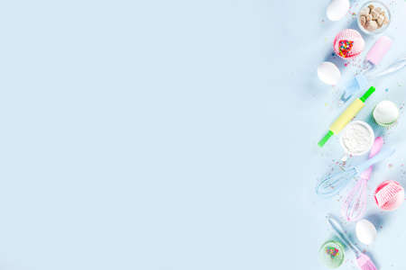 Ingredients and utensils for baking - eggs, flour, sugar, butter, milk on a light blue background.Top view copy space for text.の写真素材