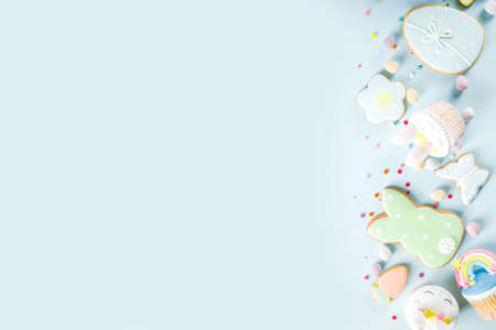 Easter holiday greeting card background. Cute homemade cupcakes with traditional Easter bunny, egg...
