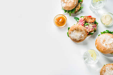 Various seafood and fish burgers assortment. Homemade healthy burger with grilled prawn, salmon, tuna, sea bass, fresh herbs, mozzarella cheese and baby spinach.の写真素材