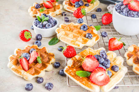 Sweet Homemade Breakfast Belgian Waffles with Berries - Strawberry and Blueberryの写真素材