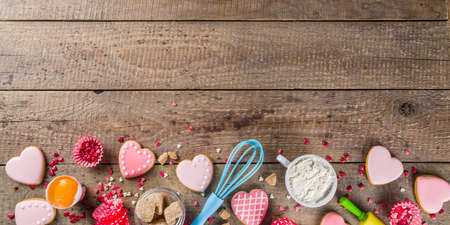 Valentine day cooking baking background. Utensils and ingredient for sweet Valentine cakes and heart...