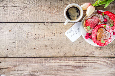 Valentine day brunch food recipe idea. Delicious homemade heart shaped red and white pancakes with...