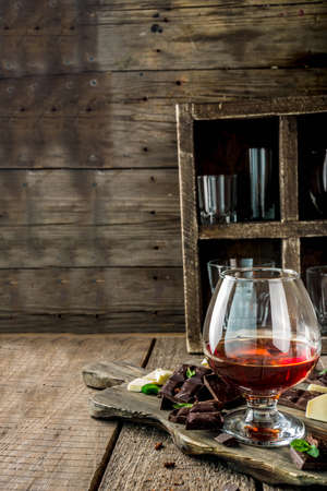 Strong alcohol drink. Glass of brandy, whiskey or cognac on the wooden tableの写真素材