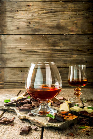 Strong alcohol drink. Glass of brandy, whiskey or cognac on the wooden tableの写真素材