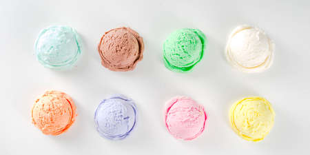 Colorful pastel ice cream with waffle cones, white background, copy space top view