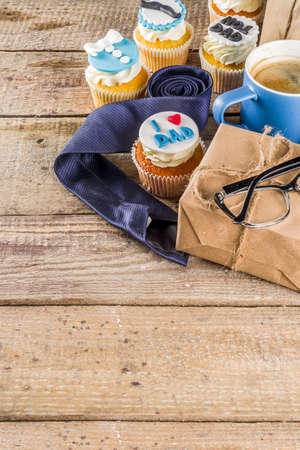 Happy Fatherâs Day greeting card.  Greetings and presents for Dad's day - gift box, coffee tea cup, tie, homemade special cupcakes. の写真素材