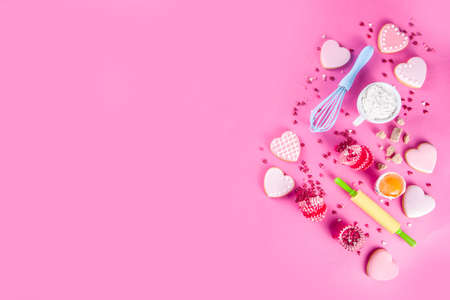 Valentine day cooking baking background. Utensils and ingredient for sweet Valentine cakes and heart shaped cookies, wooden background copy spaceの写真素材