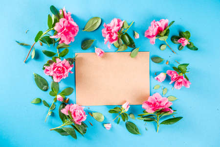 Floral pattern made of pink spring flowers, green leaves, branches on turquoise, aquamarine ...