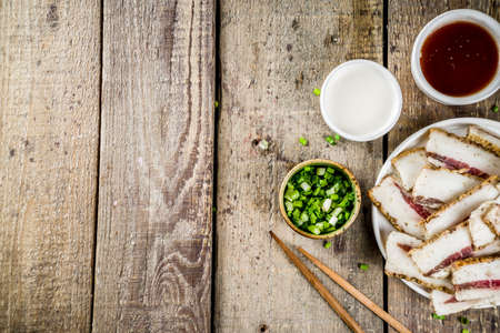 Korean traditional national food. Asian food. Korean food frozen pork belly, Sliced pork belly, Samgyeopsal. Grilled pork lard, with sauces and herbs.の写真素材