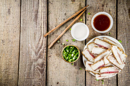 Korean traditional national food. Asian food. Korean food frozen pork belly, Sliced pork belly, Samgyeopsal. Grilled pork lard, with sauces and herbs.の写真素材