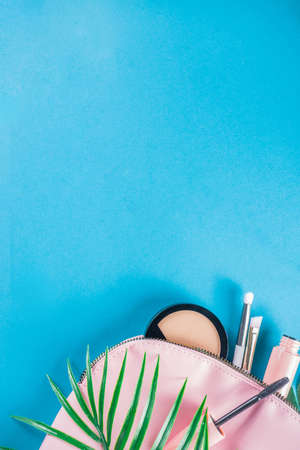 Professional makeup cosmetic set, with summer tropical leaves, woman bag. Make up items.の写真素材