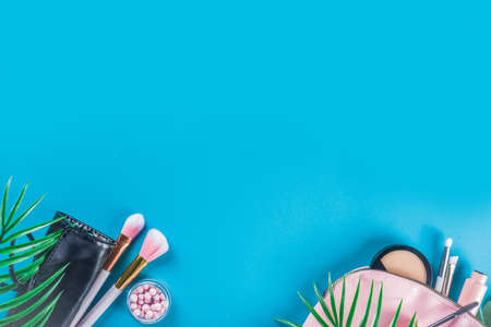 Professional makeup cosmetic set, with summer tropical leaves, woman bag. Make up items.の写真素材