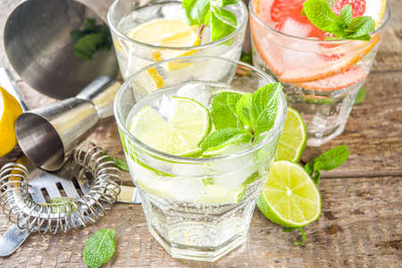 Summer detox beverage  concept. Citrus fruit drinks with ice. Healthy diet cocktail with making bar tools.  Vitamin fortified waterの写真素材