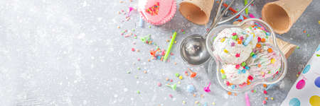 Colorful Birthday cake ice cream with Birthday decoration and ice cream waffle conesの写真素材