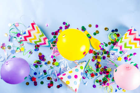Birthday party decoration background with balloons, gift boxes, steamers and confetti, trendy light blue table copy space aboveの写真素材