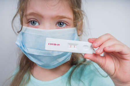 Worldwide coronavirus epidemic concept. Pandemic COVID-19, 2019-nCoV. Kid girl with positive test...