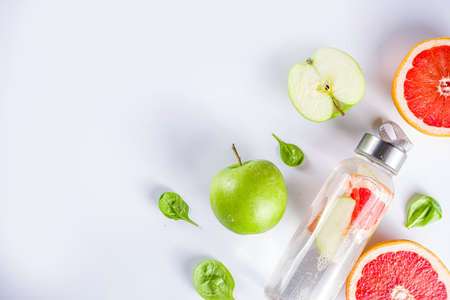 Balanced nutrition diet, fitness lifestyle concept. Fresh infused drink in glass jar. Detox water, lemonade with grapefruit and green apple.Top view flat lay backgroundの写真素材