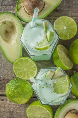 Avocado Milk Shake or Smoothie, Yogurt with Avocado and Lime Juice, with Fresh Avocados and limes on...
