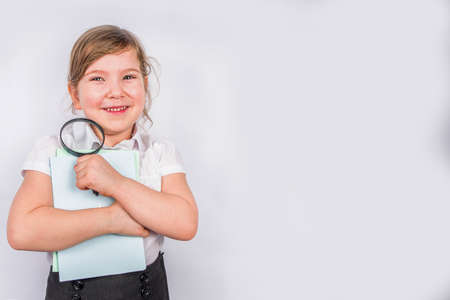 Back to school concept background. Education background. Little cute kid girl with books, magnifying...