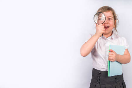 Back to school concept background. Education background. Little cute kid girl with books, magnifying...