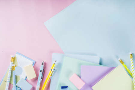 Pastel colored workspace flat lay, Minimal workplace or school study table, with pen, pencils and notebooks, Creative flat lay with pastel stationery. Top view with copy spaceの写真素材