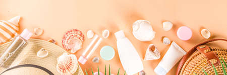 Summer cosmetics background. Summer skincare, sunscreen cosmetics, travel kit miniatures flat lay....