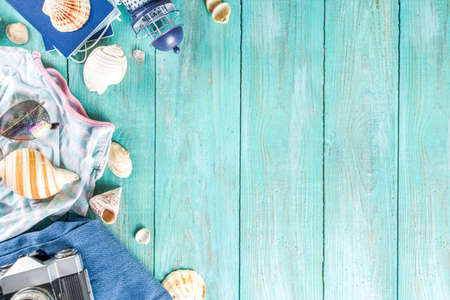 Bright  summer flat-lay background. Old blue wooden background with with summer woman clothes, sun...