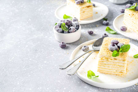 Homemade baked cake Napoleon, Millefeuille. Delicate custard cake garnished with berries and mint....
