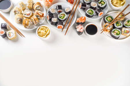 Japanese food. Big sushi set. Assorted set of various sashimi, maki and sushi rolls with different fillings - tuna, sea bass, salmon, shrimp, vegetables. Flatlay copy spaceの写真素材