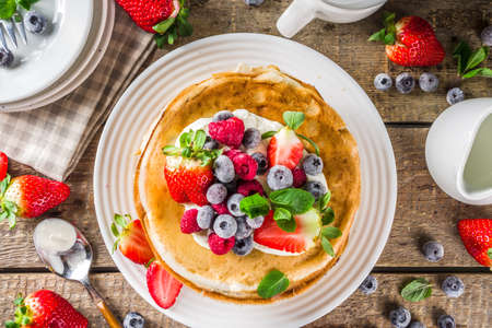 Sweet french and russian style homemade pancake crepes. Layered crepe cake with whipped cream or mascarpone cheese and fresh berries, の写真素材