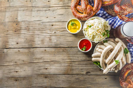 Bavarian German holiday traditions. Oktoberfest food and beer glass mug. Background for congratulations with Oktoberfest, autumn restaurant menu.の写真素材