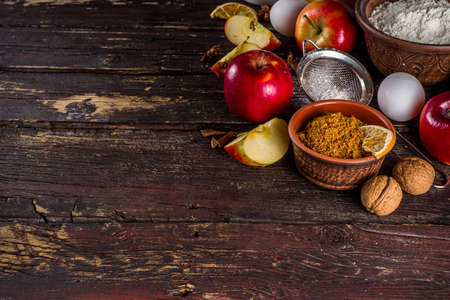 Autumn baking concept. Cooking baking background with ingredients, spices and utensils. All you need for baking traditional autumn apple pie, on rustic wooden background copy spaceの写真素材