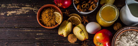 Autumn baking concept. Cooking baking background with ingredients, spices and utensils. All you need for baking traditional autumn apple pie, on rustic wooden background copy spaceの写真素材