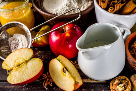 Autumn baking concept. Cooking baking background with ingredients, spices and utensils. All you need for baking traditional autumn apple pie, on rustic wooden background copy spaceの写真素材