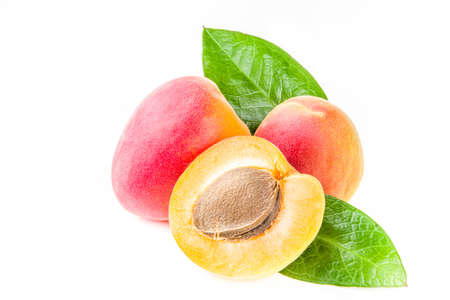 Raw whole and half sliced apricots. Fresh summer apricots fruits isolated on white backgroundの写真素材