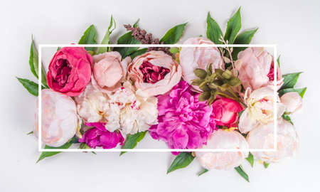 Flat lay of flowers and green leaves. Tender Peonies and chrysanthemums bloom pattern, composition...