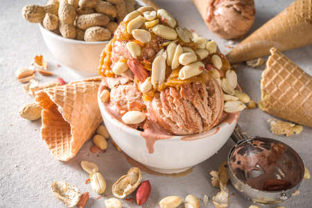 Peanut butter ice cream. Sweet peanut ice cream with peanut butter topping and a lot of peanuts, on...