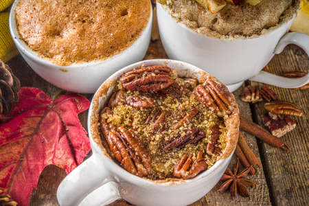 Fall and winter sweet dessert.  Traditional Autumn Cakes, Microwave Mug Pies -  Mug Pumpkin Pie, Apple Crumble Crisp Pie, Pecan Mug Cakeの写真素材