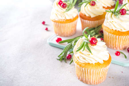 Gingerbread Christmas Cupcakes with sugared cranberry and rosemary, copy space
