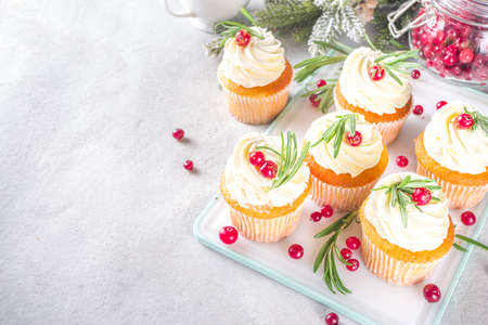 Gingerbread Christmas Cupcakes with sugared cranberry and rosemary, copy spaceの写真素材