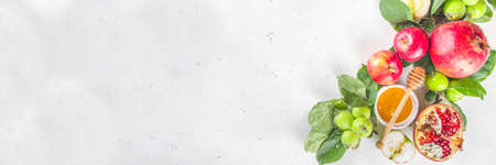 Rosh hashanah, jewish New Year holiday concept, banner. With traditional symbols, apples, pomegranate, honey. Rosh hashanah greeting card background.の写真素材