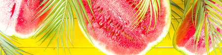Watermelon on yellow wooden background. Bright summer sun lighted wooden background with Watermelon...