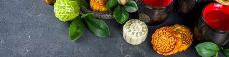 Traditional Chinese sweet dessert. Homemade Chinese snow skin and baked mooncakes, Chinese Mid-Autumn Festival food, colorful rice cakes, flatlay top view copy space