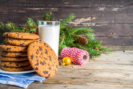 Christmas concept with milk and cookies to Santa, rustic wooden xmas greeting card backgroundの写真素材