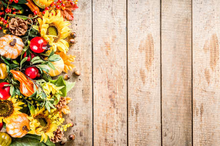 Festive autumn background, still life decor with pumpkins, berries, leaves on wooden background. Concept background for Thanksgiving or Halloween holiday, copy space, flatlayの写真素材